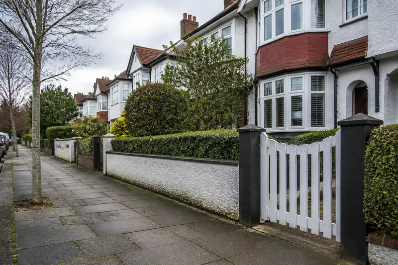 A low front wall and gate beside a pavement