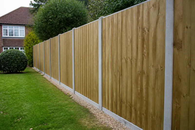 A new closeboard fence with concrete posts along a garden